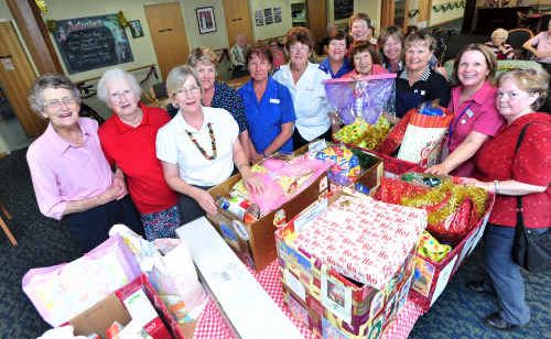 Masonic Aged Care Hostel staff and residents donating boxes of Christmas cheer to Di Walters of the Salvos. Masonic Aged Care Hostel staff and residents donating boxes of Christmas cheer to Di Walters of the Salvos.